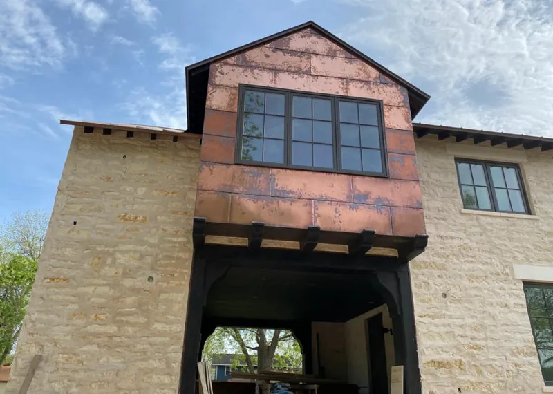 Copper metal panel facade on a stone building for Metal Roof Coating in Aiken